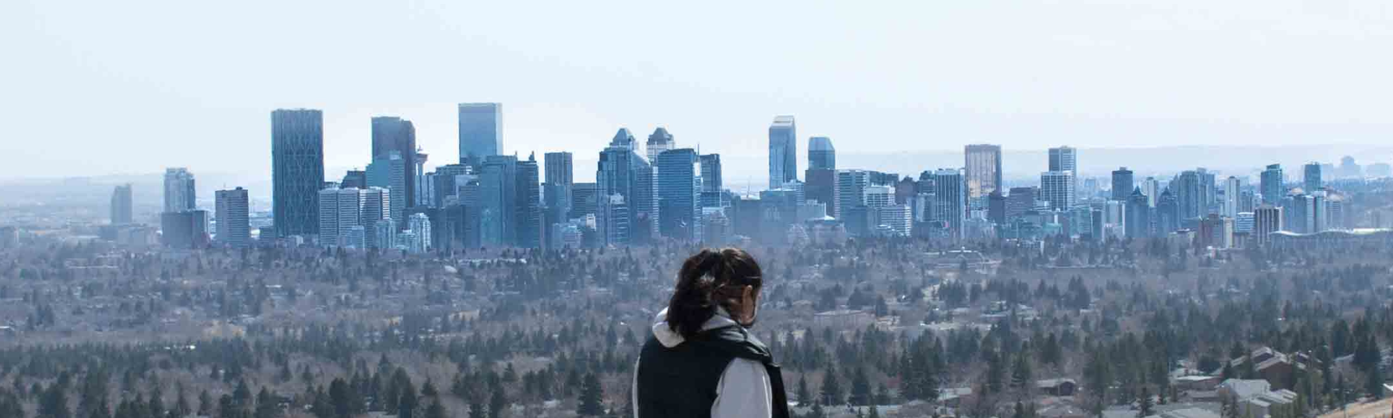 A member of YouQuest on a walk overlooking the city skyline in the Calgary community.